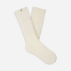 Made from a soft rib knit and crafted with Responsible Cotton, the Tyla Slouchy Crew sock is designed for a slouchier fit. | Slouchy Cotton sock. 97% Cotton/2% Recycled Polyester/1% Elastane. Made from Responsible Cotton. 11 inch height. Soft twill tape with The UGG® Logo on top cuff. Fits shoe size: 5-10. Imported. | UGG® Women's Tyla Slouchy Crew Sock Cotton Blend Socks in Nimbus Warm Casual Socks For Loungewear, Casual Warm Socks For Loungewear, Casual Solid Socks For Stocking Stuffers, Casual Solid Color Socks For Stocking Stuffers, Casual Solid Color Knee-high Socks, Casual Solid Color Socks, Cozy Winter Socks With Ribbed Cuffs, Comfortable Warm White Knee-high Socks, Casual Warm Knee-high Socks For Stocking Stuffers