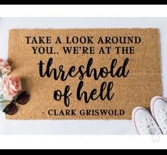 a door mat that says take a look around you, we're at the threshold of hell