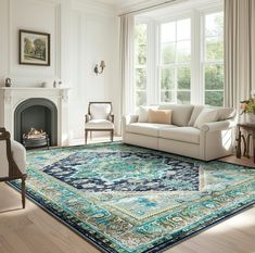 a living room filled with furniture and a large rug on top of a hard wood floor