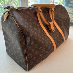 Authentic Louis Vuitton M41424 Keepall 55; Includes Original Lock And Keys In Box Good Used Condition. No Visible Rips Or Tears. Includes Lock And Key Current Msrp: $2,170.00 Date Code: Sd1004 (The Date Code Indicates A Production Date Of: October 2004 In France Or The United States (After 1995)) Condition: Monogram Canvas In Very Good Shape; No Rips Or Holes; Vibrant Monogram Print Color; Clean Interior And No Foul Odor; Zipper Works Perfectly; Excellent Hardwares; Beautiful Light Honey Patina Color Throughout Leather; Minimal Hairline Scratches And Stains On Leather Handle And Trims Minor Scratches On Leather Pipings; 8/10 Overall Condition Product Details From Website: The Keepall Louis Vuitton Travel Bags, Patina Color, Monogram Prints, Lock And Key, Id Holder, Beautiful Lights, Monogram Canvas, Authentic Louis Vuitton, Leather Handle