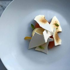 a white plate topped with food on top of a table