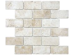 a white brick wall that is made out of several different types of stone tiles, including one