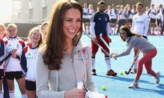 the young women are playing tennis together on the court with other people in the background