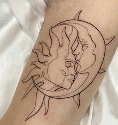 a tattoo on the leg of a person with a sun and moon in it's center