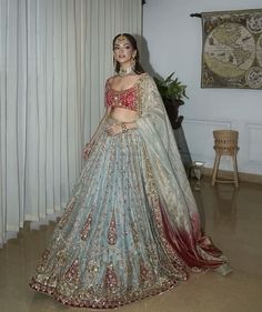 a woman in a blue and red lehenga