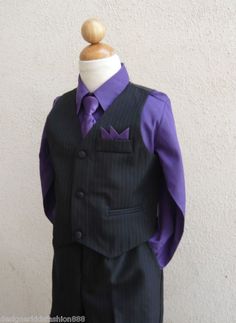 a mannequin wearing a suit and purple shirt