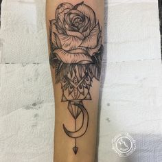 a black and white photo of a rose with a crescent on the side of a leg