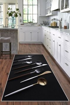 a kitchen area rug with spoons and utensils laid out on the floor