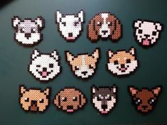 pixelated animal heads are displayed on a green surface in this image, there is a black background with several different types of dogs