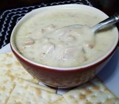 a bowl of soup with crackers on the side