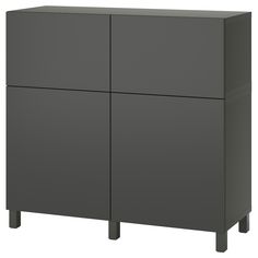 a gray cabinet with three doors and two legs on the bottom, in front of a white background