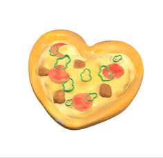 a yellow heart shaped cookie with toppings on it's side, in the shape of a pizza