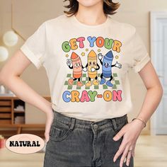 a woman wearing a t - shirt that says get your crayon on