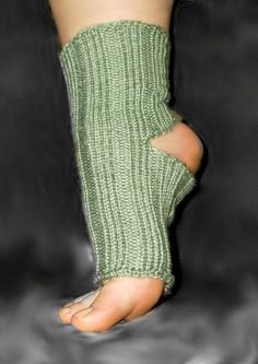 there is a person wearing a green knitted leg warmer with holes in the middle