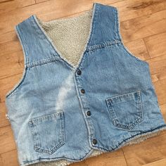 "This piece is a very nice vintage jean vest from the 1980s that is fully lined with sherpa. This snap button up vest has two patch pockets on the front and a super beautiful fade, one that only comes with time and wear.  -Tag is completely washed out -Some fraying at the side seam (pictured) Tag Size: N/A *refer to measurements for true fit* Pit to Pit: 21\" Length: 21.5\" Please also assess the photos and measurements carefully using your own personal judgement as we do not accept returns. Keep in mind that this is a piece of vintage clothing that may hold a residual scent from its past. While we wash all of the clothing we sell (except for certain items which are steam cleaned) we cannot guarantee that we have been able to remove all of the stubborn scents. Buyers should be prepared for Medium Wash Denim Vest For Winter, Winter Medium Wash Washed Denim Vest, Sleeveless Cotton Denim Vest For Winter, Vintage Denim Vest In Medium Wash For Winter, 80s Denim, Jean Vintage, Jean Vest, Vest Outfits, Sherpa Lined