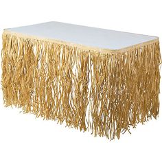 a white table with gold fringe on it