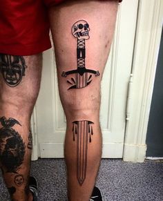 two people with tattoos on their legs and one has a knife in the other's leg