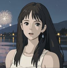 a woman with long black hair standing in front of fireworks