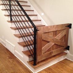 a wooden stair case with metal handrails