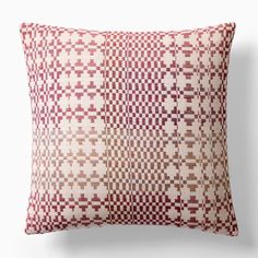 a red and white pillow with squares on it