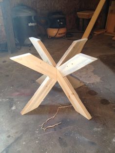 a wooden snowflake sitting on top of a floor