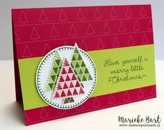 a handmade christmas card with an ornament on the front and green border