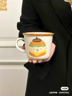 a person in a suit holding a coffee cup with a cartoon character on the side