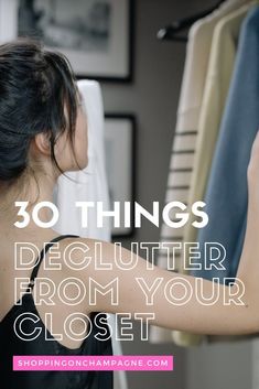 a woman looking at clothes on a rack with the words 30 things declutter from your closet