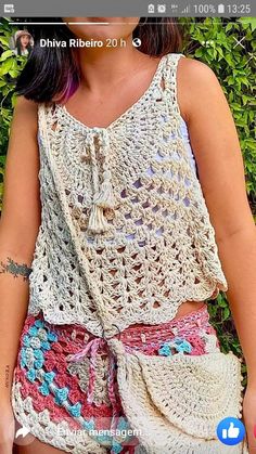 a woman wearing shorts and a crochet top