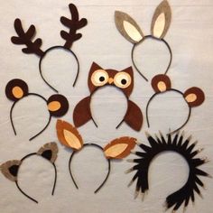 an assortment of animal headbands made out of wood and paper with eyes, ears, nose, and tail