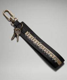 a keychain with the word warrior on it and two keys attached to it