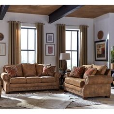 a living room with two couches, a chair and a coffee table in it