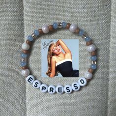 a bracelet with beads that say espresso and an image of a woman on it