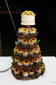 a wedding cake made out of cupcakes and sunflowers