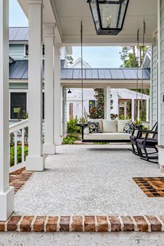 a porch with swings and chairs on it