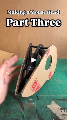 a cardboard box with scissors in it and the words making a mouse head part three