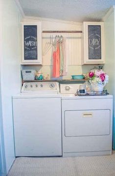 a washer and dryer in a laundry room with chalkboards on the wall