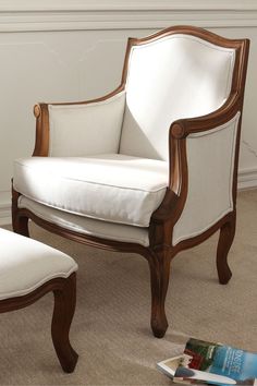 a white chair and ottoman in a room