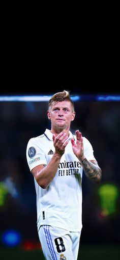 a soccer player is applauding with his hands together