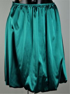 Balloon skirt emerald green Length 55 cm, waist 39 cm Wash at 30o Green Flowy Party Skirt, Green Flowy Skirt For Party, Satin Full Skirt For Night Out, Elegant Green Pleated Skirt, Green Long Skirt For Party, Green Full Skirt For Party, Green Pleated Party Skirt, Green Flowy Formal Skirt, Formal Green Flowy Skirt