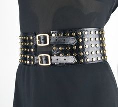 This 3in (8cm ) wide belt with metal buckles and gold metal studs is made of stiff calf leather with a gloss finish. With to its unique design, this belt will accentuate the waist and create a flattering feminine shape. This belt will fit many styles - Steampunk, Biker, Goth, Punk, Cowboy. You can wear this corset belt with dresses and blouses, it can even be worn over a cloak or jacket. Add this fashionable item to your wardrobe and you will not leave anyone indifferent! Other models of wide wa Black Chain Belt With Belt Loops For Festivals, Black Chain Belt For Festival, Edgy Fitted Belt For Night Out, Trendy Corset Belt With Belt Loops For Party, Trendy Corset Belt For Parties, Includes Belt, Trendy Corset Belt For Party, Trendy Belt Buckles With Matching Belt For Party, Party Belts With Rivets, Edgy Corset Belt With Removable Belt For Night Out