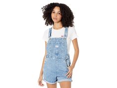 Levi's(r) Womens Vintage Shortall - Women's Jumpsuit & Rompers One Piece : Mini Indigo : Give your look a vintage feel with this Levi's Womens shortall. Relaxed-fit overalls boast tacked cuffs. Adjustable shoulder straps attach at the bib. Single pocket at bib. Front hand pockets. Back patch pockets boast signature arcuate stitch and red tab detail. Triple button closure at sides. 65% cotton, 35% lyocell. Machine wash and tumble dry. Imported. Measurements: Inseam: 5 1 2 in Product measureme Utility Style Shortalls With Pockets And Relaxed Fit, Utility Style Relaxed Fit Shortalls With Pockets, Relaxed Fit Utility Shortalls With Pockets, Casual Denim Shortalls With Belt Loops, Relaxed Fit Shortalls With Side Pockets, Medium Wash Cotton Shortalls With Adjustable Straps, Medium Wash Shortalls With Adjustable Straps, Cotton Relaxed Fit Shortalls With Adjustable Straps, Retro Relaxed Fit Overalls With Pockets