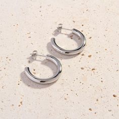 Stock your jewelry box with our new, better-than-basic Bijou Cali Silver Hoops. These lovely silver hoop earrings are slightly smaller than our classic Cali Silver Hoops. They’ll look amazing with your favorite silver jewellery pieces. Perfectly weighted and designed with simple and clean lines, these dainty hoops are an essential day-to-night accessory. We love wearing the Bijou Cali Hoops with a lace blouse and tailored slacks for daytime events, or pairing them with a flirty going-out dress a Minimalist Metal Hoop Earrings With Polished Finish, Minimalist Shiny Finish Hoop Earrings For Everyday, Minimalist Shiny Hoop Earrings For Everyday, Everyday Minimalist Hoop Earrings With Shiny Finish, Minimalist White Gold Huggie Earrings, Classic Silver Hoop Earrings For Everyday, Everyday White Gold Metal Hoop Earrings, Minimalist Earrings With Shiny Finish For Everyday, Minimalist Shiny Finish Earrings For Everyday