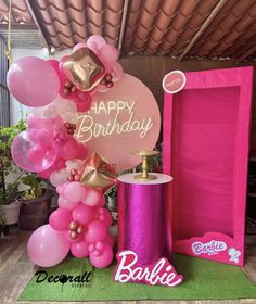 a birthday party with balloons and decorations in pink, gold and white colors on display