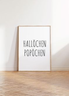 an empty room with a framed poster on the wall that says, hallochen popoffen