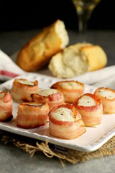 bacon wrapped scallops on a white plate