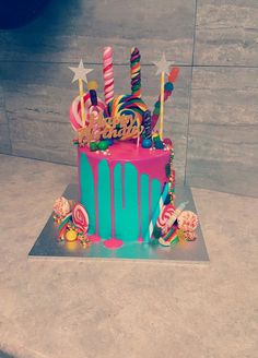 a colorful birthday cake sitting on top of a table