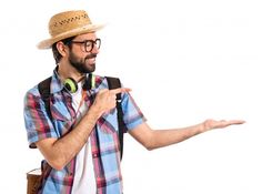 a man wearing headphones and a straw hat is holding out his hand to someone