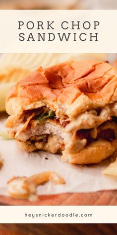 the pork chop sandwich has been cut in half and is sitting on top of some chips