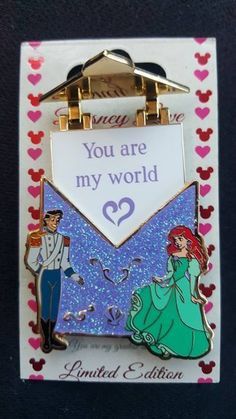 a disney pin with an envelope on it that says, you are my world 2